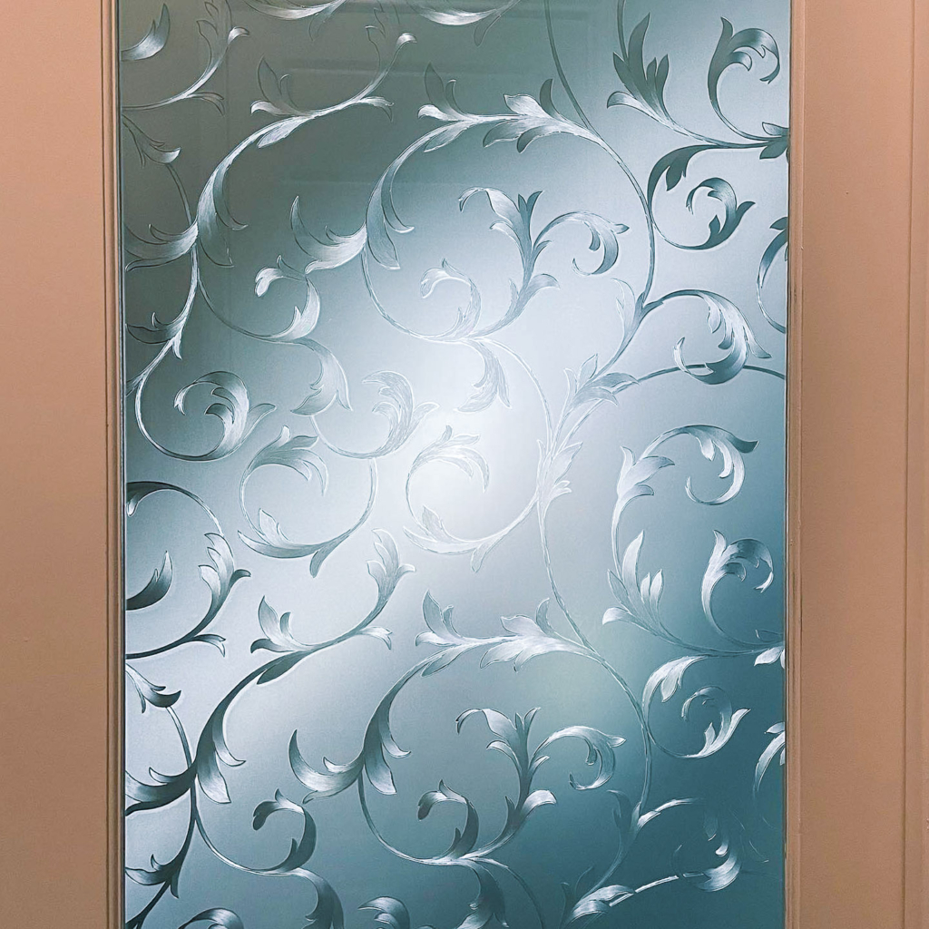 Close-up of decorative window film with an elegant swirl design